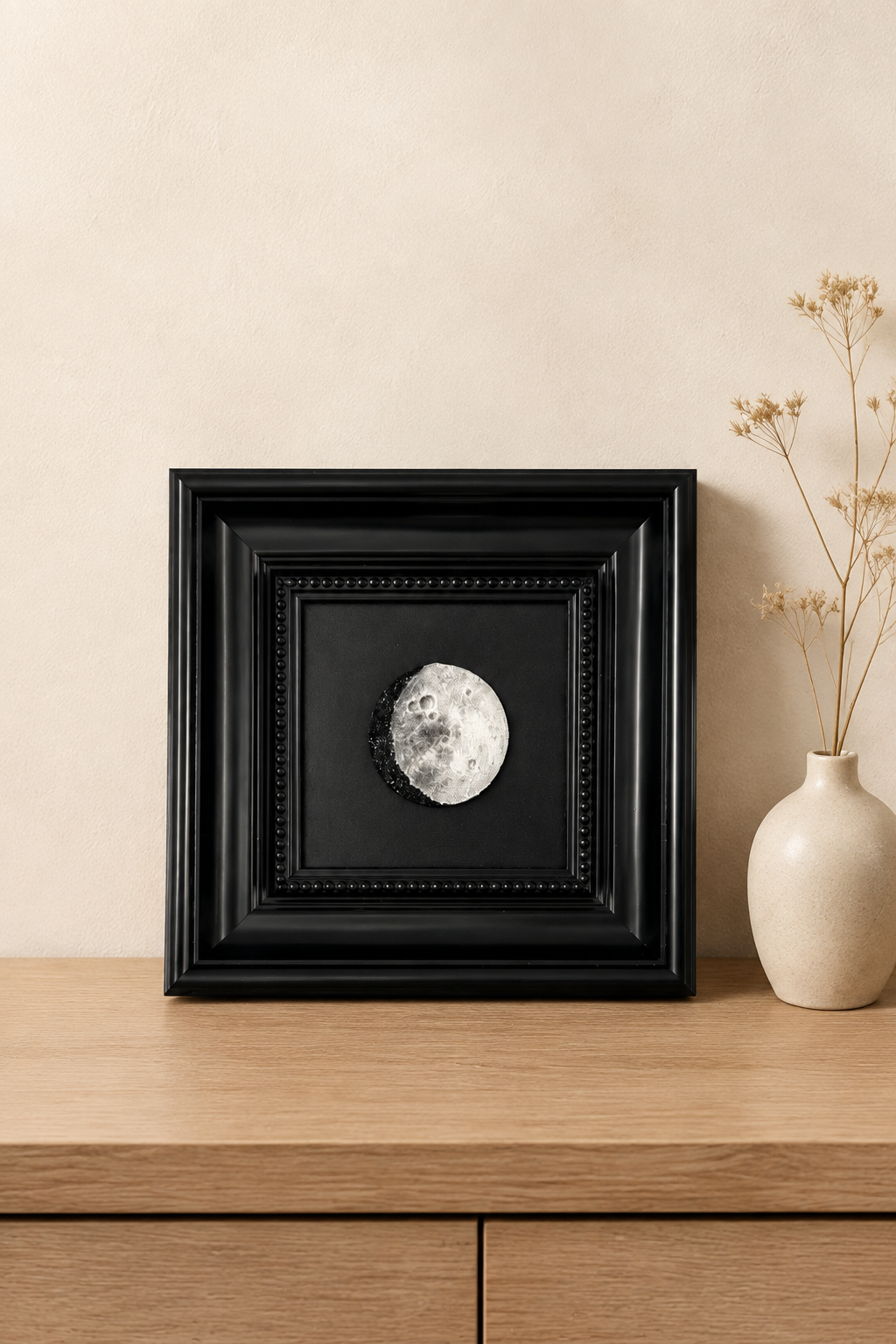 Personalized moon phase artwork displayed above a wooden console